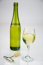 Glass of White Wine shot with a bottle of white wine.