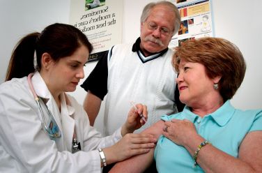 Middle aged woman was receiving an intramuscular vaccination int